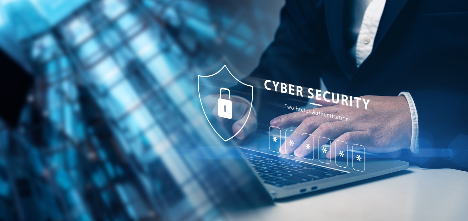 Person tippend an Laptoptastatur mit visuellem Logo zu Cyber Security